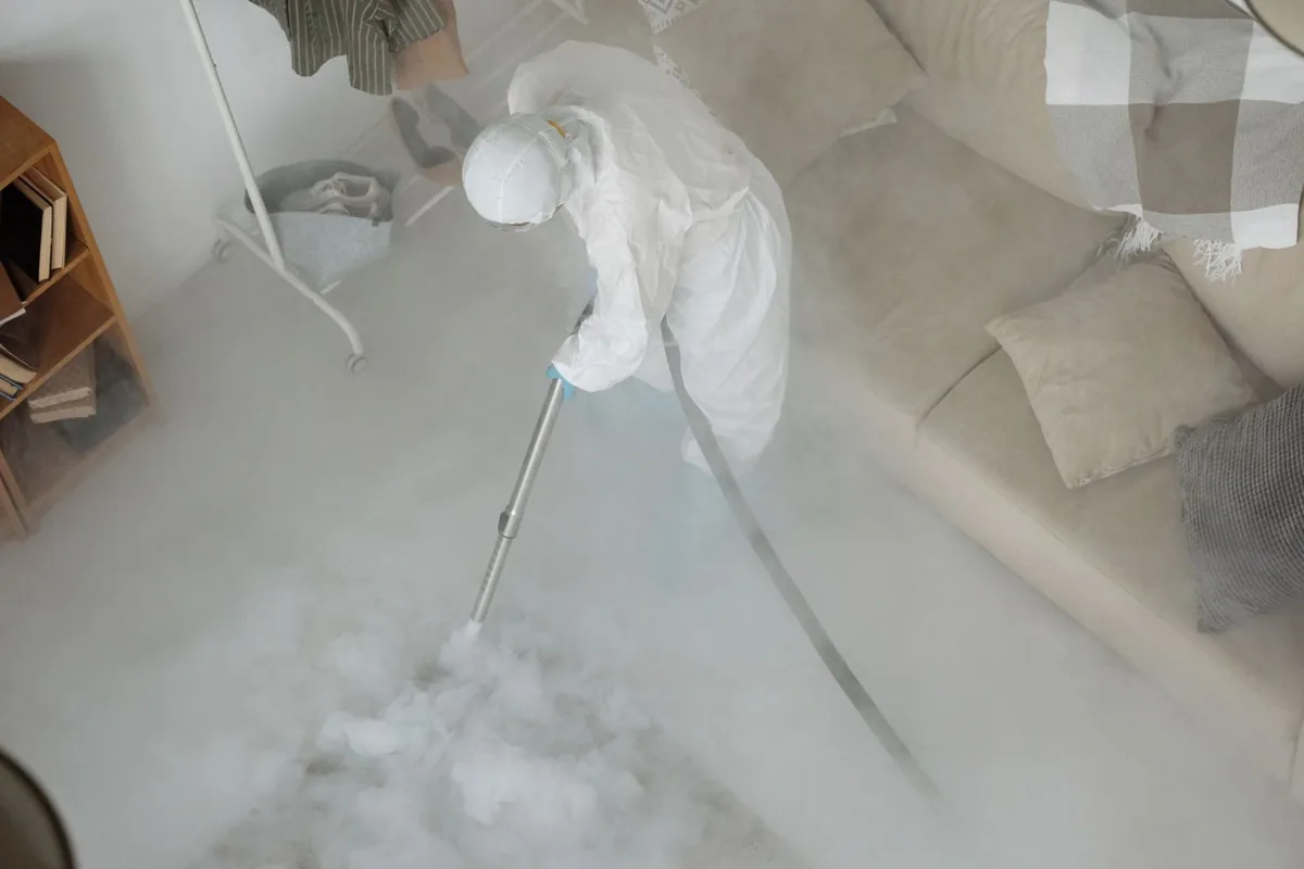 Biohazard cleanup technician in protective equipment, Mandeville, LA